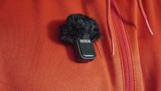 Rode Wireless Micro transmitter attached to a bright orange jacket